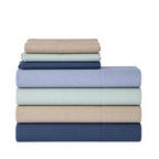 A stack of five folded bedding sheets in muted pastel and neutral colors, including Cappuccino, Mint, navy, and Purple, on a plain white background.