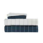Home Co. Isabella Sheet Set shown folded in coordinating navy and white designs, featuring fine stripe detailing.