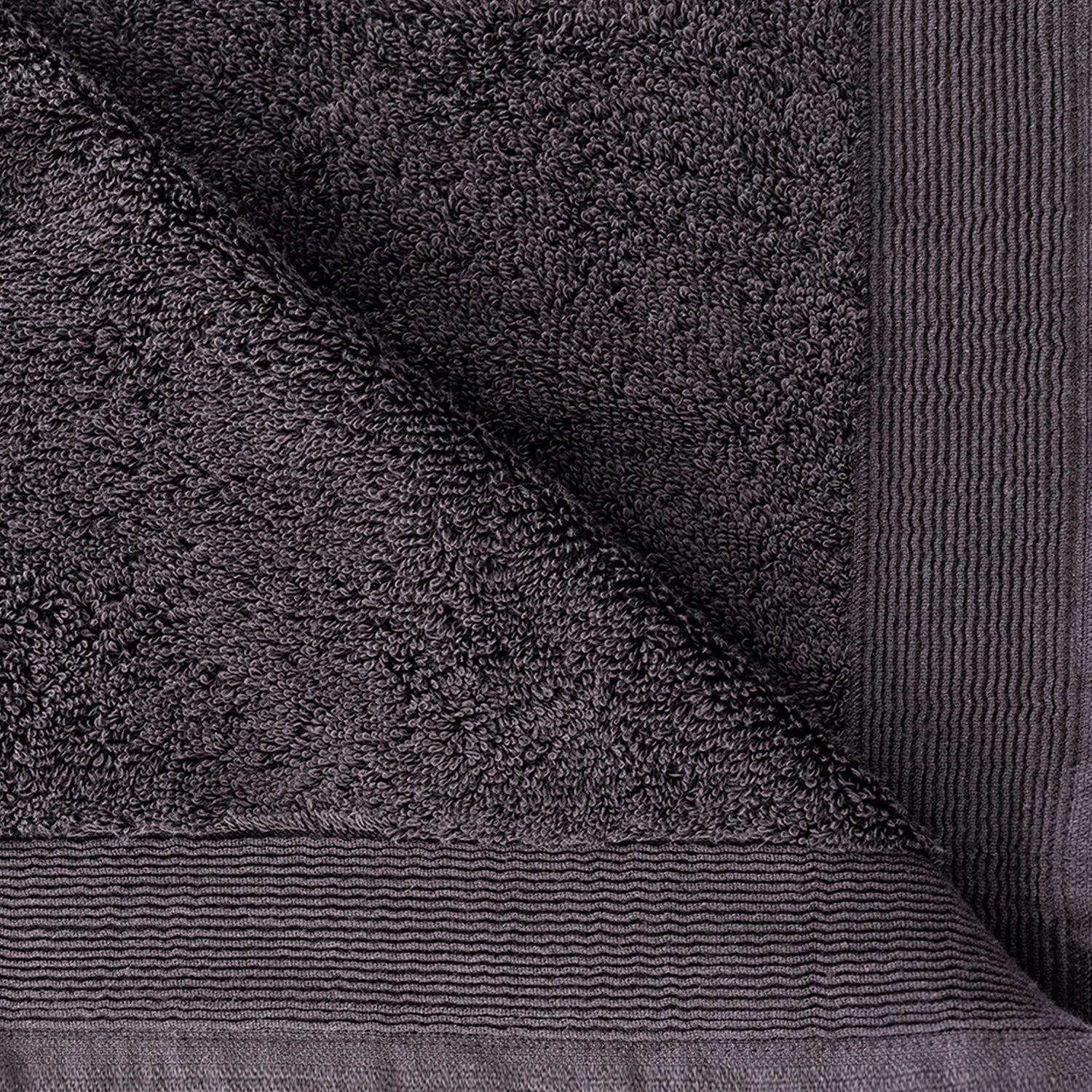 Close-up of the Charcoal Egyptian cotton towel showing the soft looped texture and decorative border.