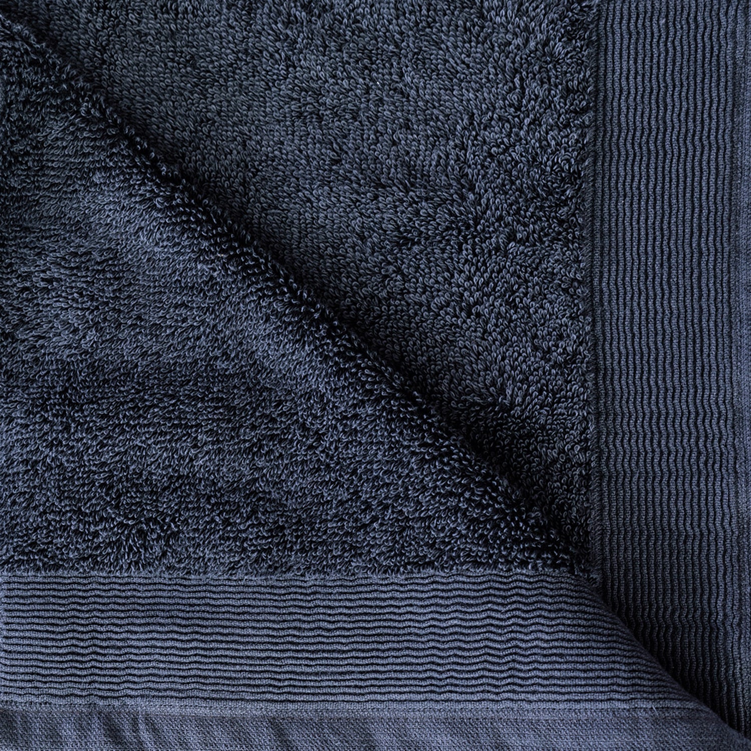 Close-up of the Diesel Blue Egyptian cotton towel showing the soft looped texture and decorative border.