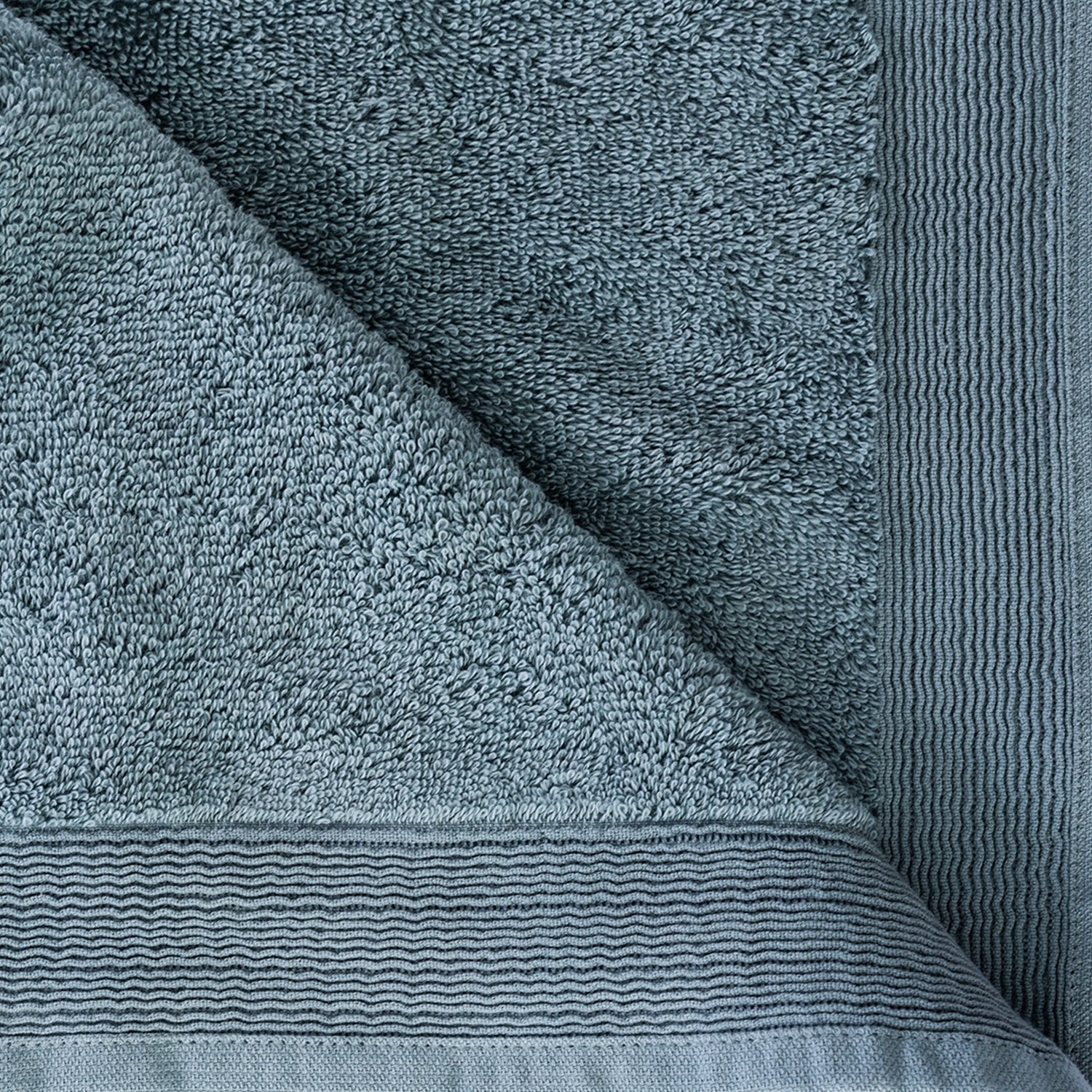 Close-up of the Marine Egyptian cotton towel showing the soft looped texture and decorative border.