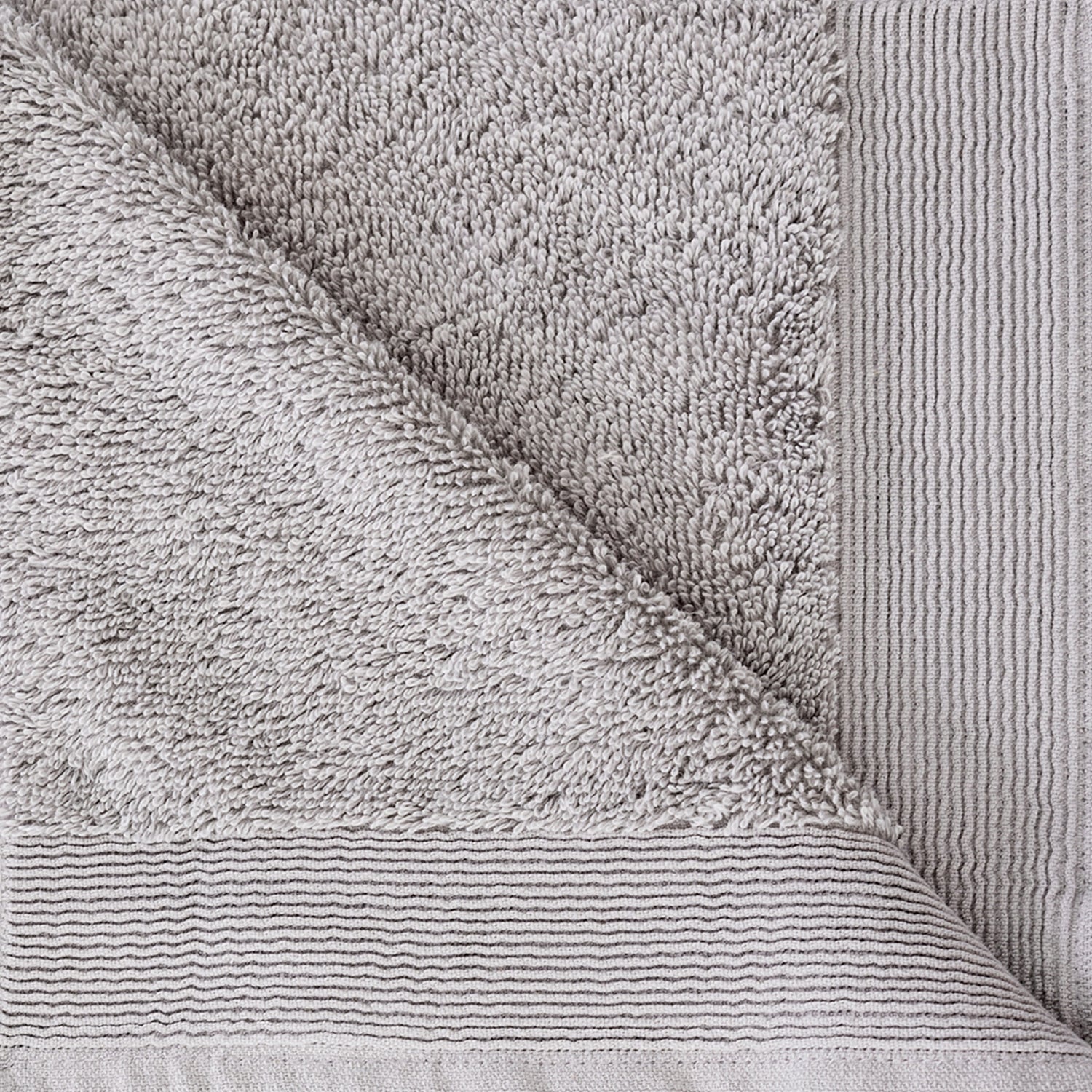 Close-up of the Silver Egyptian cotton hand towel showing the soft looped texture and decorative border.