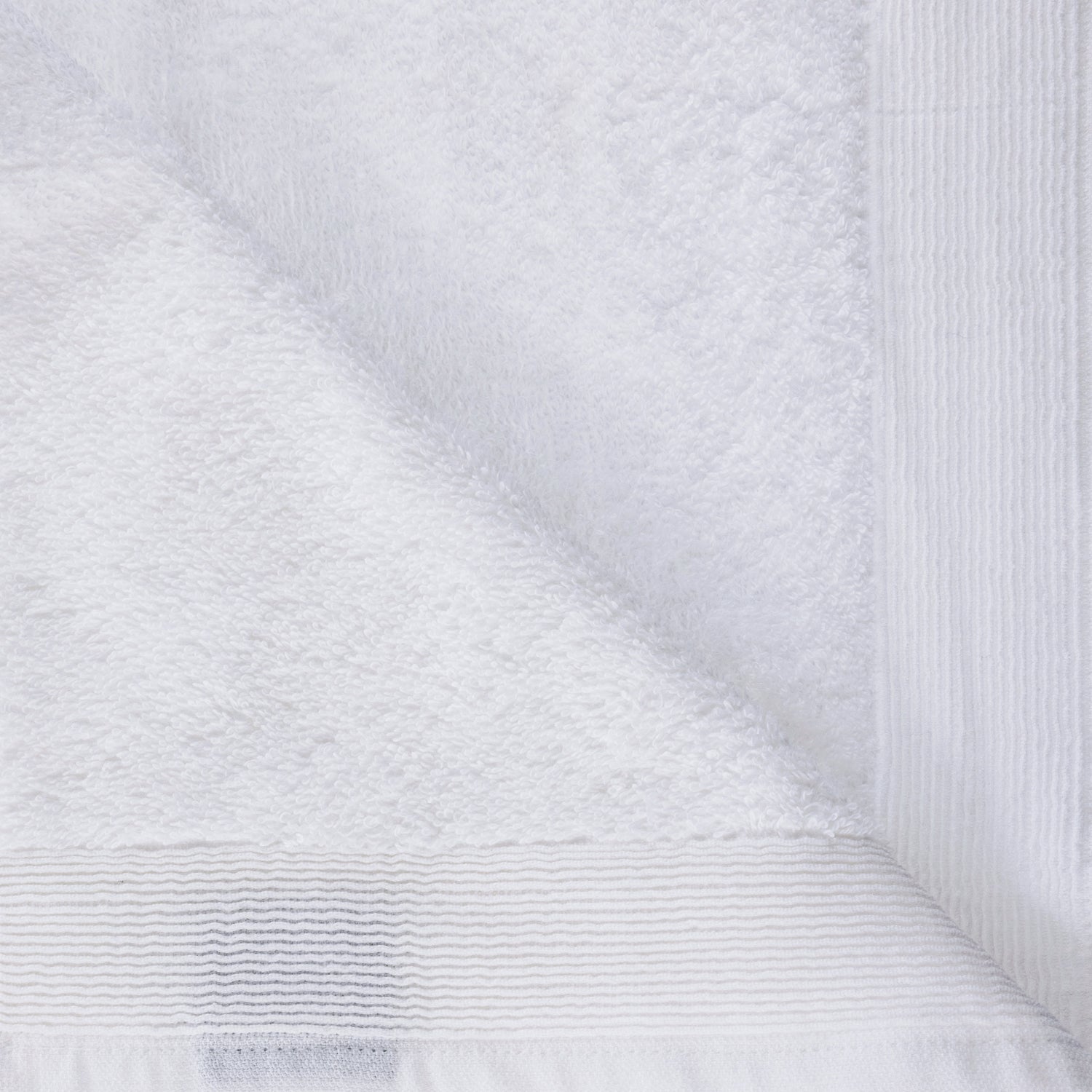 Close-up of the White Egyptian cotton hand towel showing the soft looped texture and decorative border.