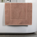 Brick bath mat hanging over bath tub