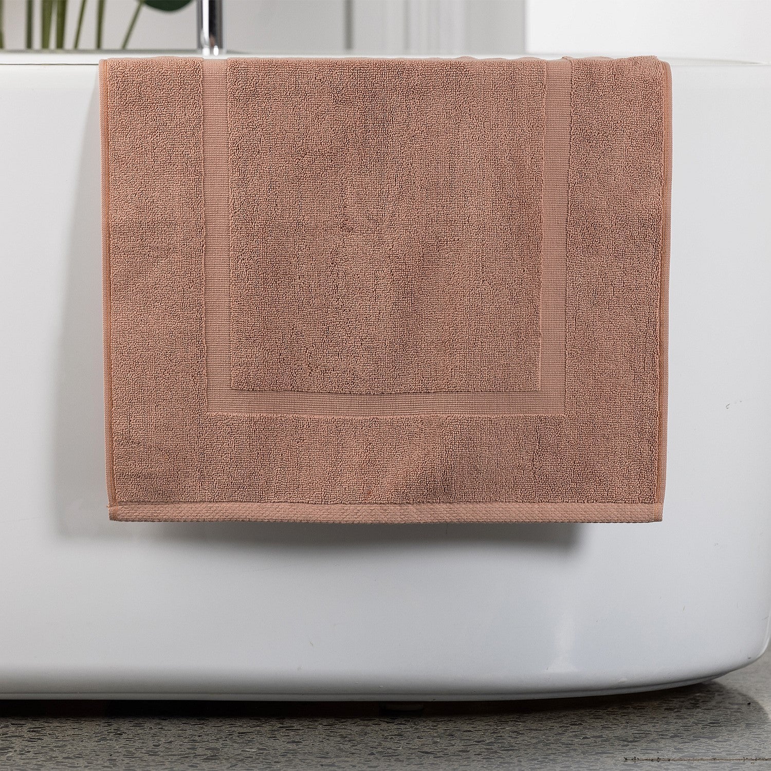 Brick bath mat hanging over bath tub