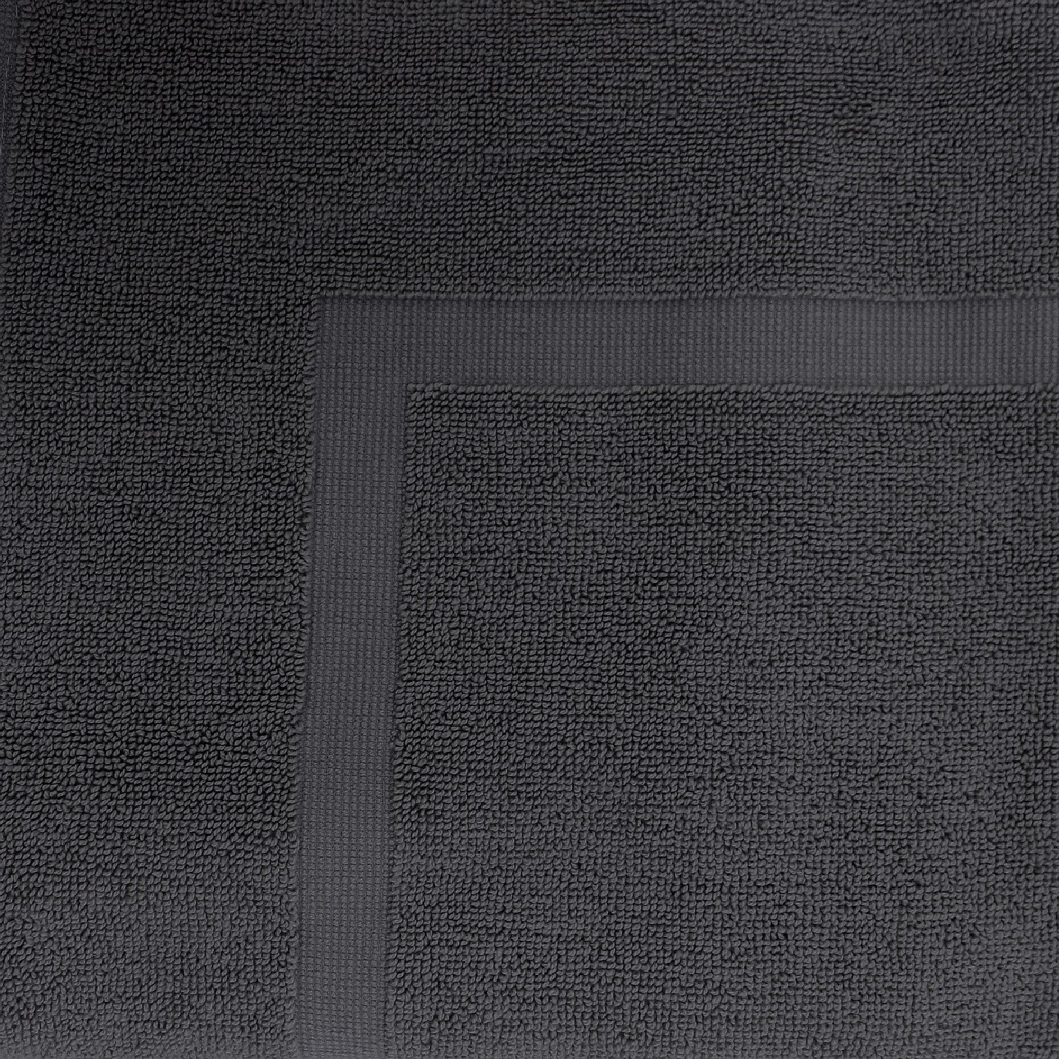 Close-up of a Coal  towel featuring a soft textured pile and classic border detailing.