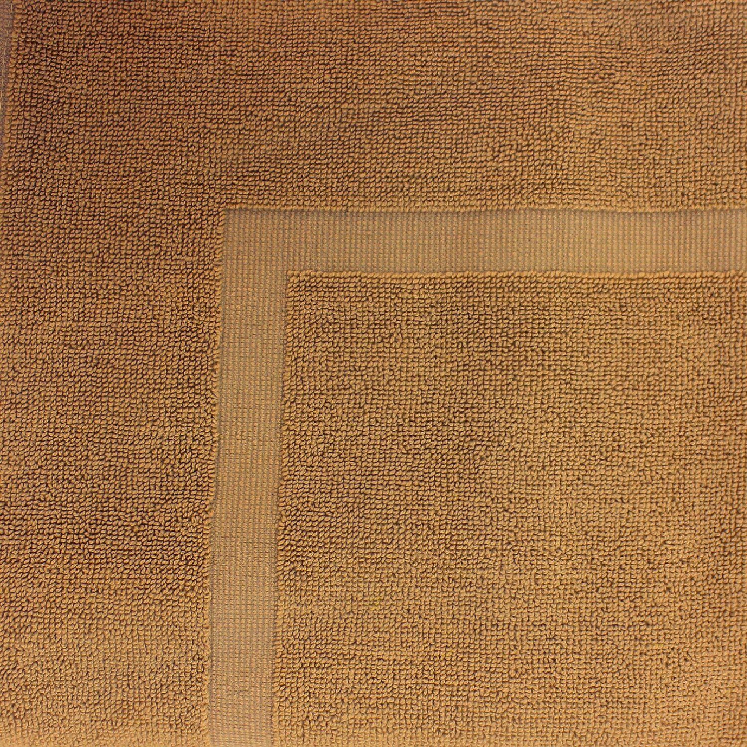 Close-up of a Mustard towel featuring a soft textured pile and classic border detailing.
