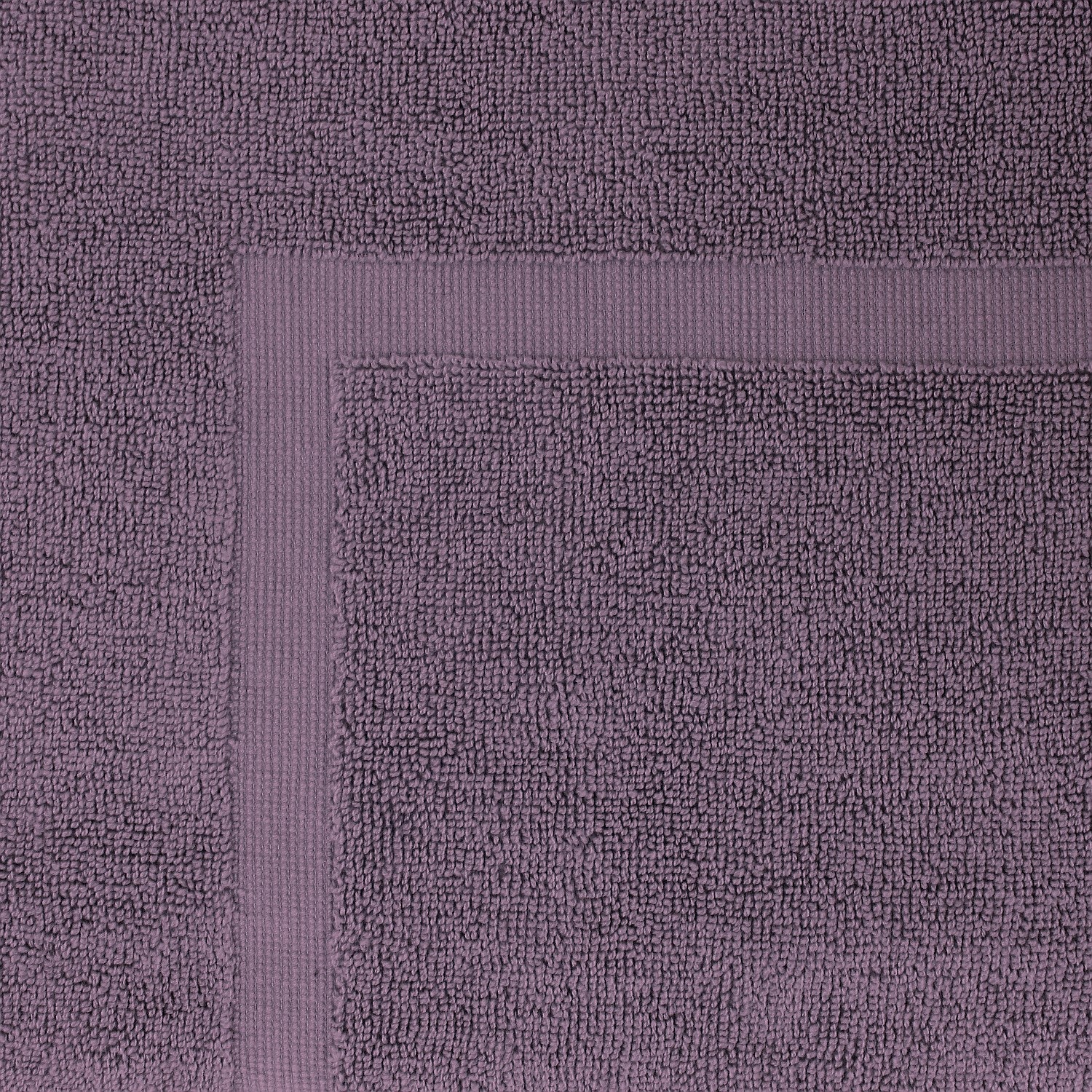Close-up of a Plum  towel featuring a soft textured pile and classic border detailing.