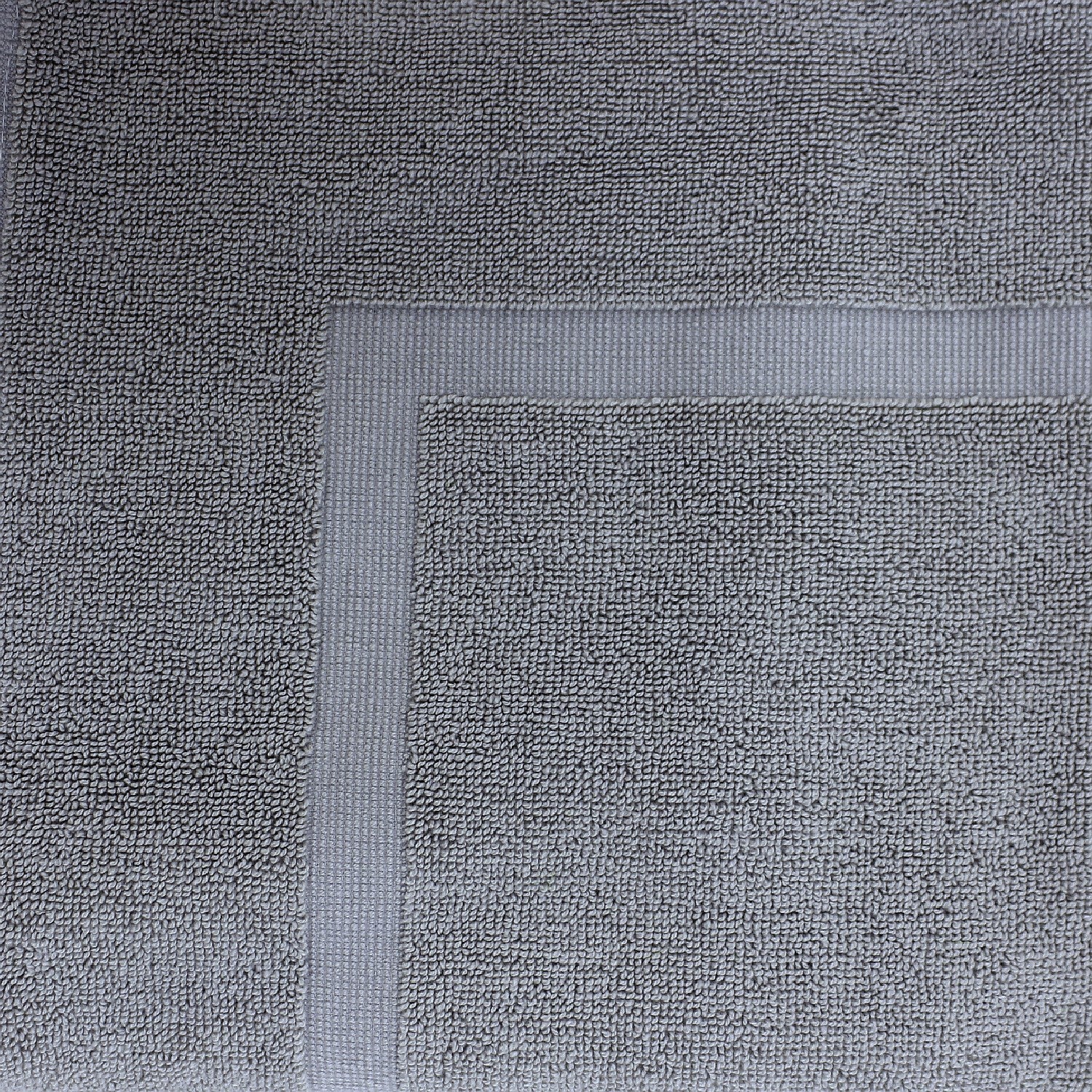 Close-up of a Steel Grey towel featuring a soft textured pile and classic border detailing.