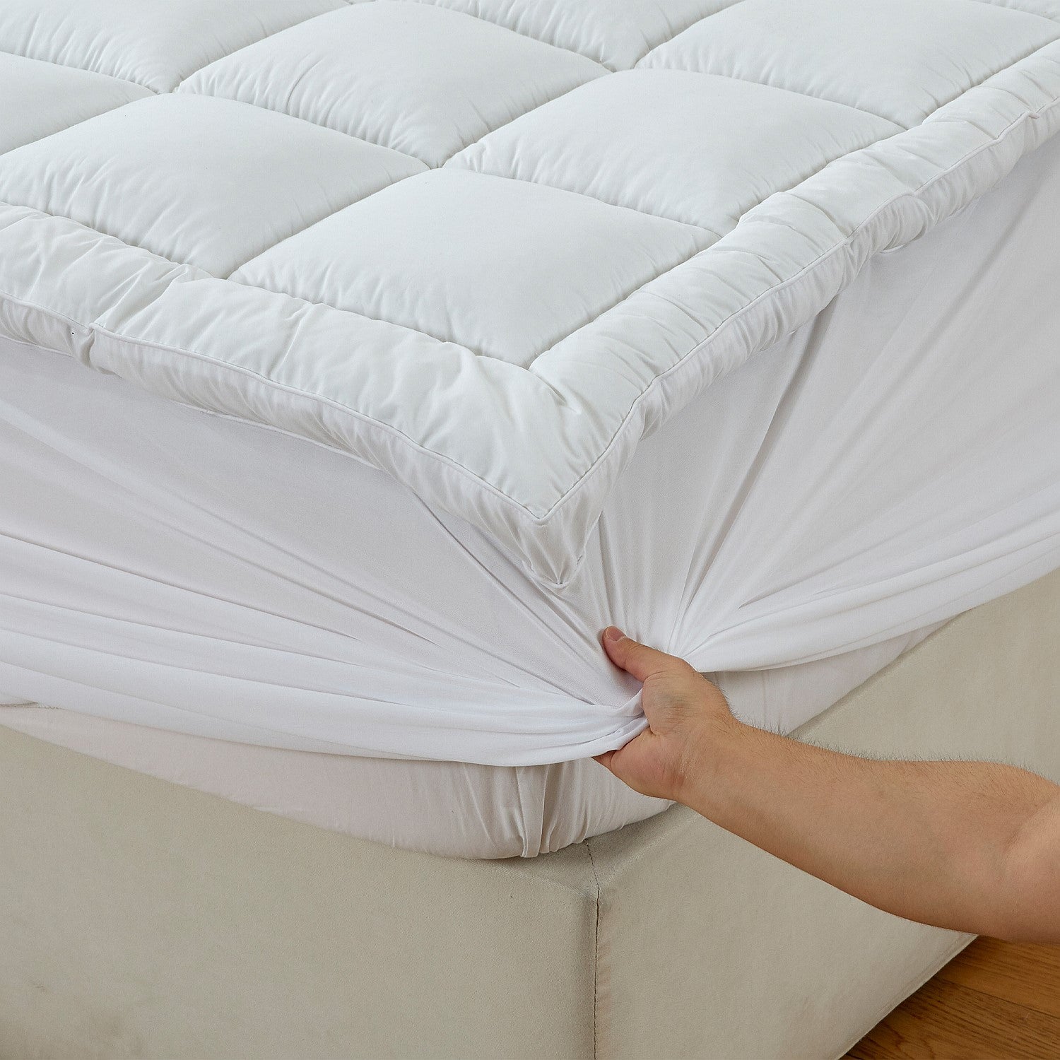 Up close of the Luxury High Loft Mattress Topper corner to show how it fits on the bed