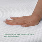 Close-up of a hand pressing into the mattress surface, highlighting the antibacterial and anti-mite fabric with soft comfort support.