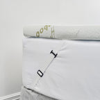 Close up of the bambou mattress topper attached to the ed with elastic straps 