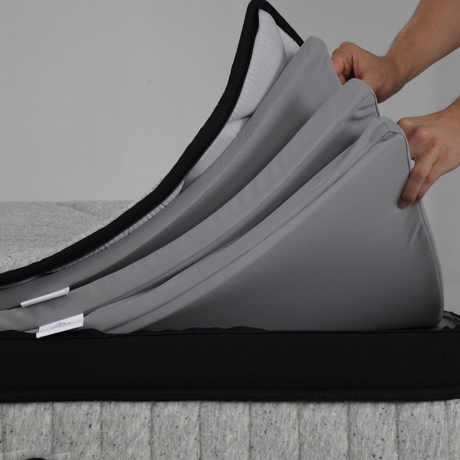Close-up of the Cloud 9 Luxe Adjustable Mattress with removable and adjustable foam comfort layers being lifted to customise personalised sleep support.