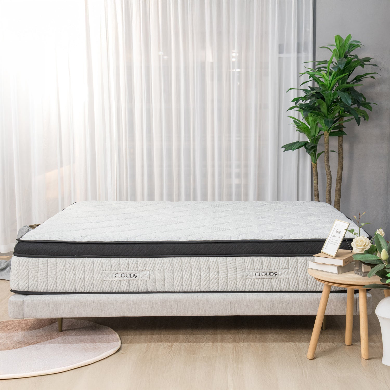 Front view of the Cloud 9 mattress featuring a plush quilted finish and layered comfort design, styled in a bright contemporary bedroom setting.