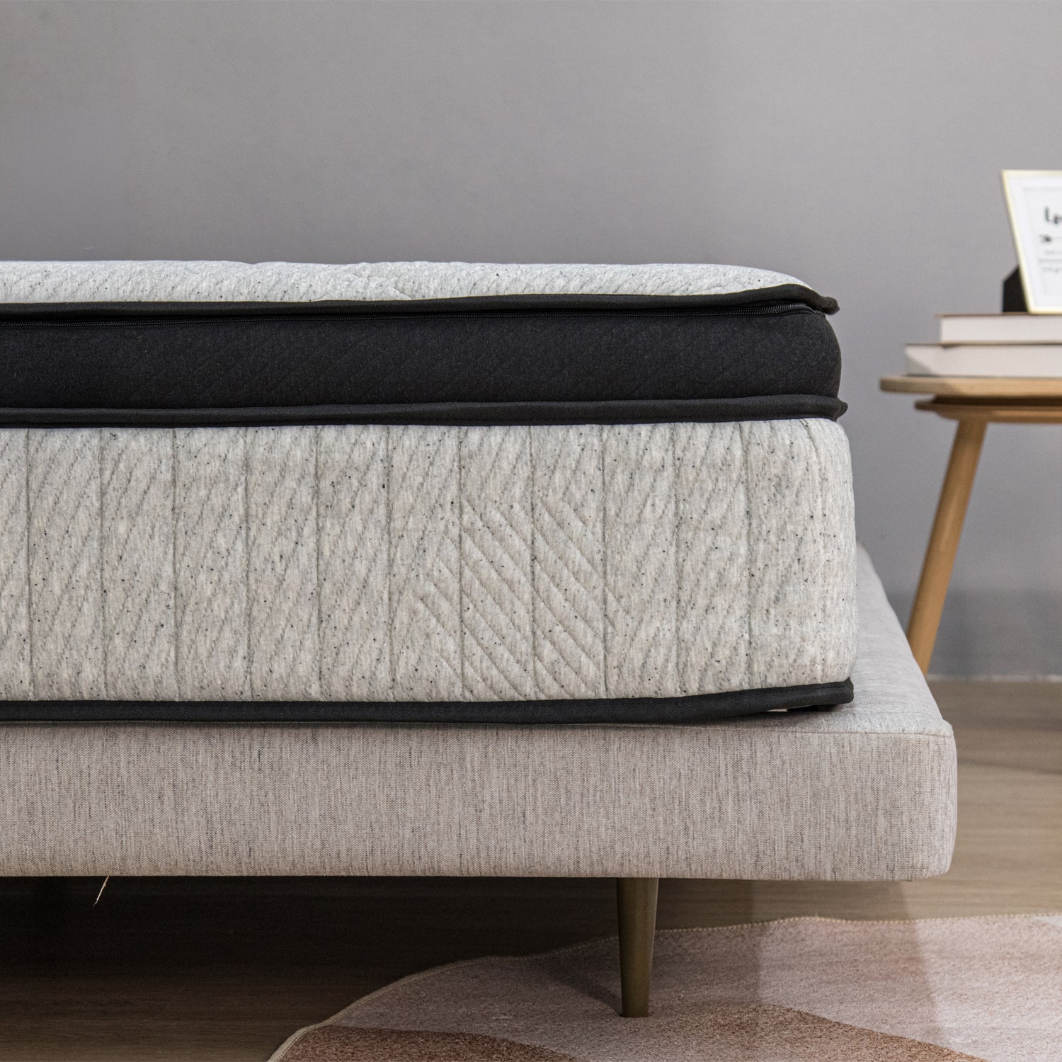 Close-up side profile of the Cloud 9 mattress showcasing its layered pillow-top design and textured fabric finish in a contemporary bedroom setting.