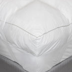 close up image of the corner of ardor mattress topper on a bed