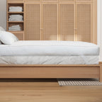 side image of the ardor mattress topper on a bed