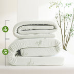 Comparison of Bambou Memory Foam Mattress Toppers showing 5cm and 10cm depth options folded on a bed, highlighting the difference in thickness and bamboo-patterned cover.