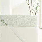 Side profile of the Bambou 10cm Memory Foam Mattress Topper secured to a mattress with an elastic corner strap, highlighting the topper's thickness and bamboo-patterned cover.
