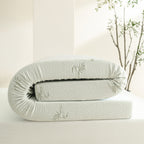Folded Bambou 10cm Memory Foam Mattress Topper displayed on a tabletop, showing the bamboo-patterned cover and thick layered memory foam construction.