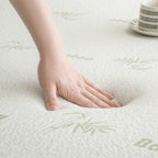 Hand pressing into the surface of the Bambou Memory Foam Mattress Topper, demonstrating the responsive contouring support and pressure-relieving memory foam.