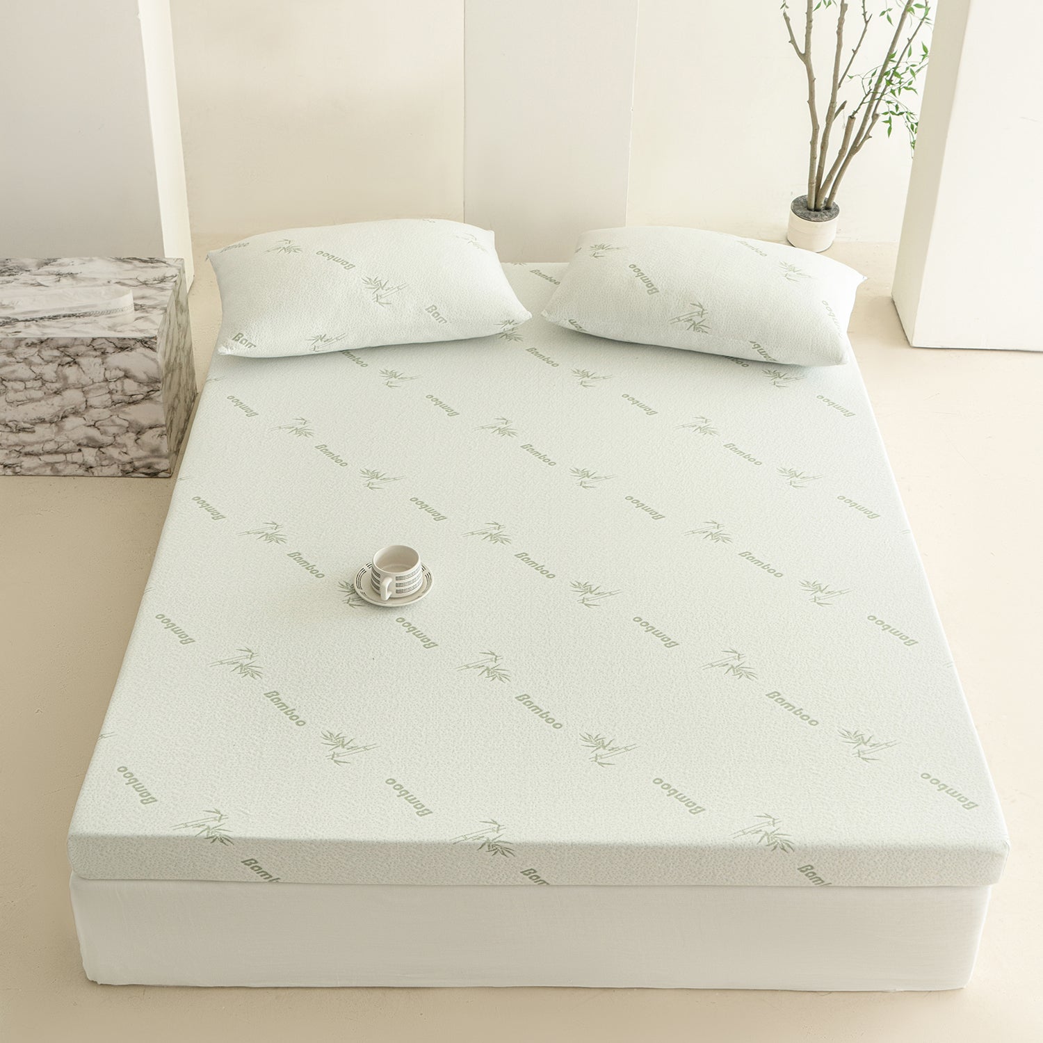 Bambou 10cm Memory Foam Mattress Topper displayed on a bed base with matching bamboo-patterned pillows in a bright, minimalist bedroom setting.