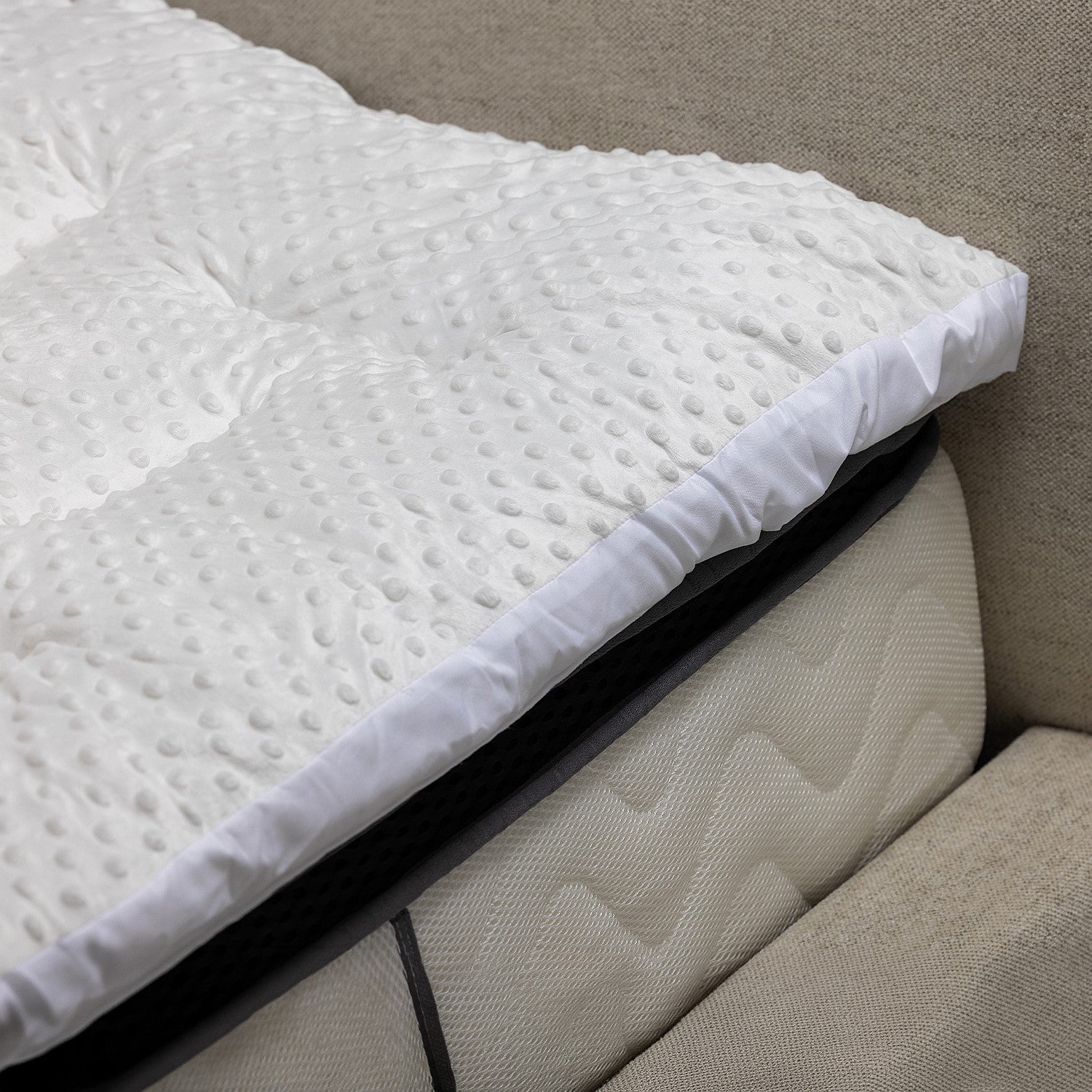 Eden Bobble Mattress Topper 800gsm on a bed