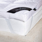 Fieldcrest duck feather and down dual layer mattress topper fitted on a mattress with elastic straps.