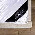Fieldcrest duck feather and down dual layer mattress topper fitted on a mattress with elastic straps.