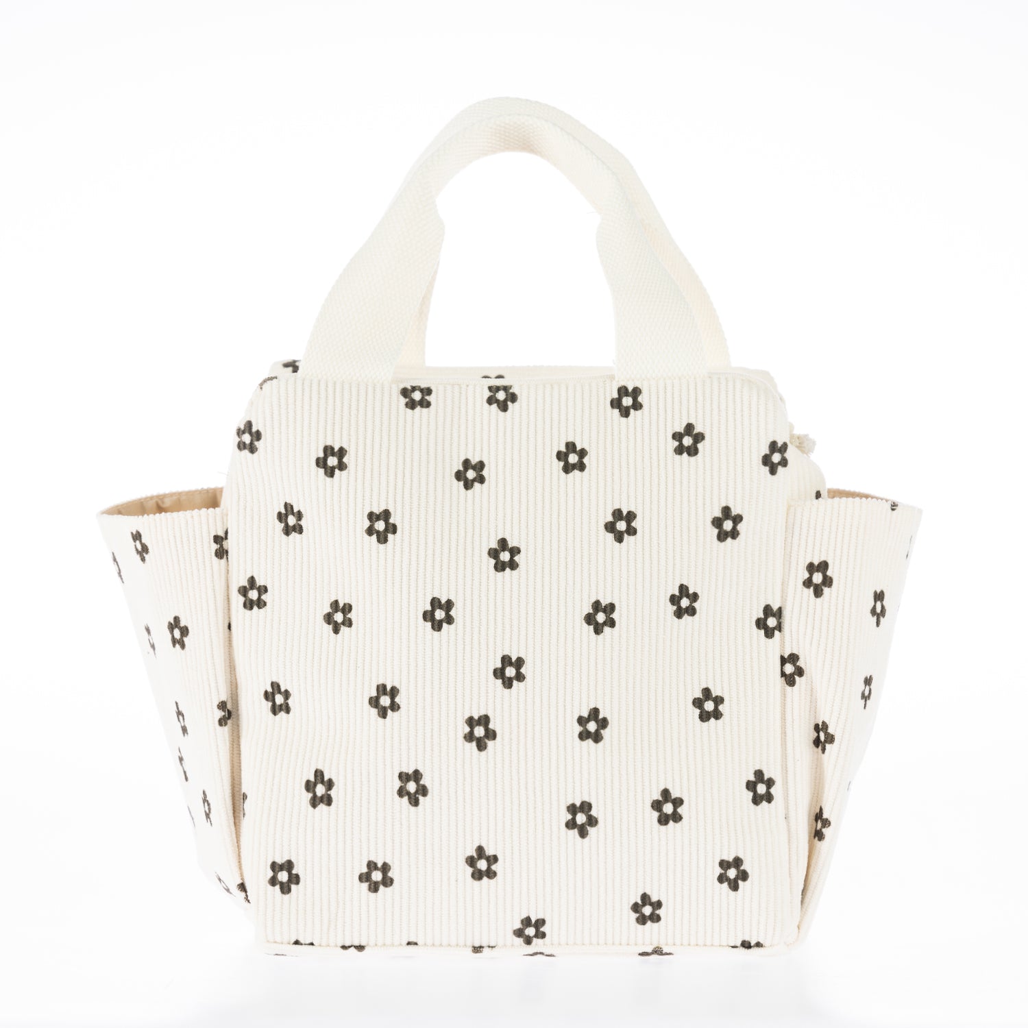 Cream corduroy lunch tote with brown daisy print, carry handles, and side pockets on a white background.