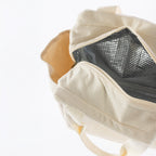 Cream corduroy lunch tote with carry handles, zip open, and side pockets on a white background.