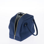 Navy lunch tote with zip closure, carry handles, and gold stud details on a white background.