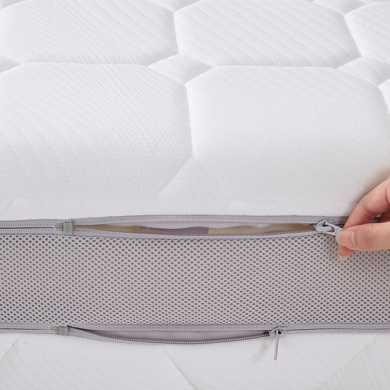 Close-up of the Cloud 9 Dual Side 7-Zone Mattress with the removable zip cover partially unzipped.