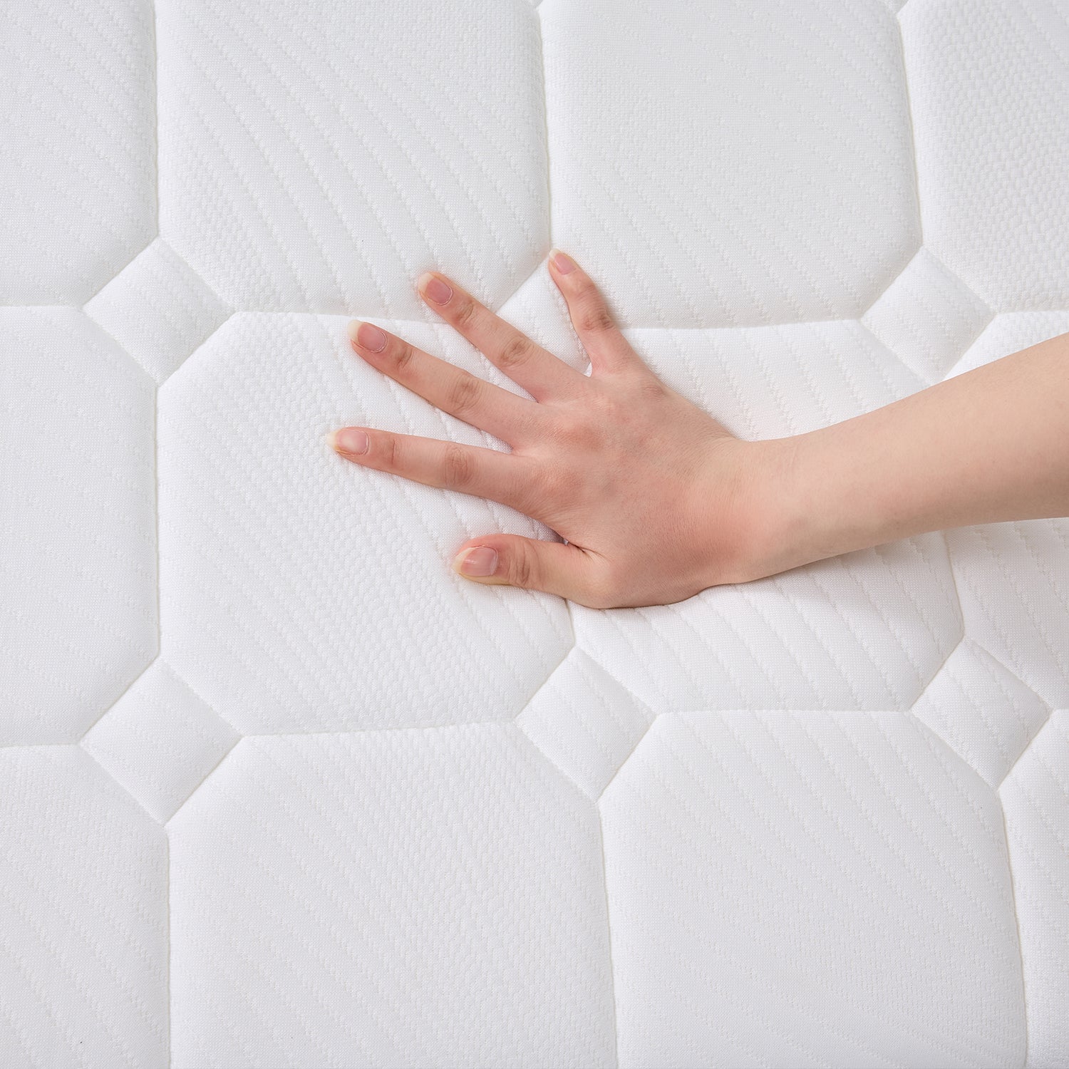 Hand pressing into the Cloud 9 Dual Side 7-Zone Mattress to demonstrate its supportive, cushioned comfort.