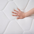 Hand pressing into the Cloud 9 Dual Side 7-Zone Mattress to demonstrate its supportive, cushioned comfort.