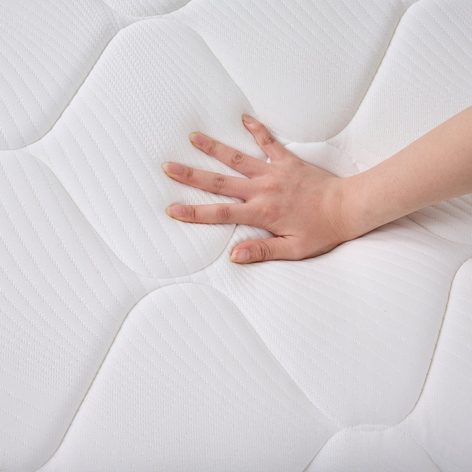 Hand pressing into the Cloud 9 Dual Side 7-Zone Mattress to demonstrate its supportive, cushioned comfort.