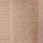 Close-up of the blush Design Plus Ivy towel showing the plush cotton texture, ribbed detailing and woven border.