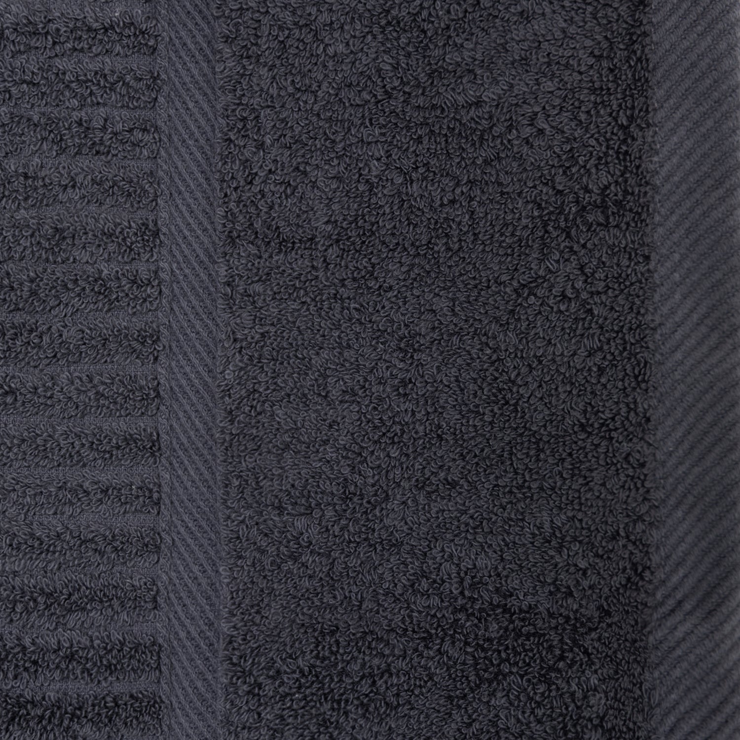Close-up of the charcoal Design Plus Ivy towel showing the plush cotton texture, ribbed detailing and woven border.