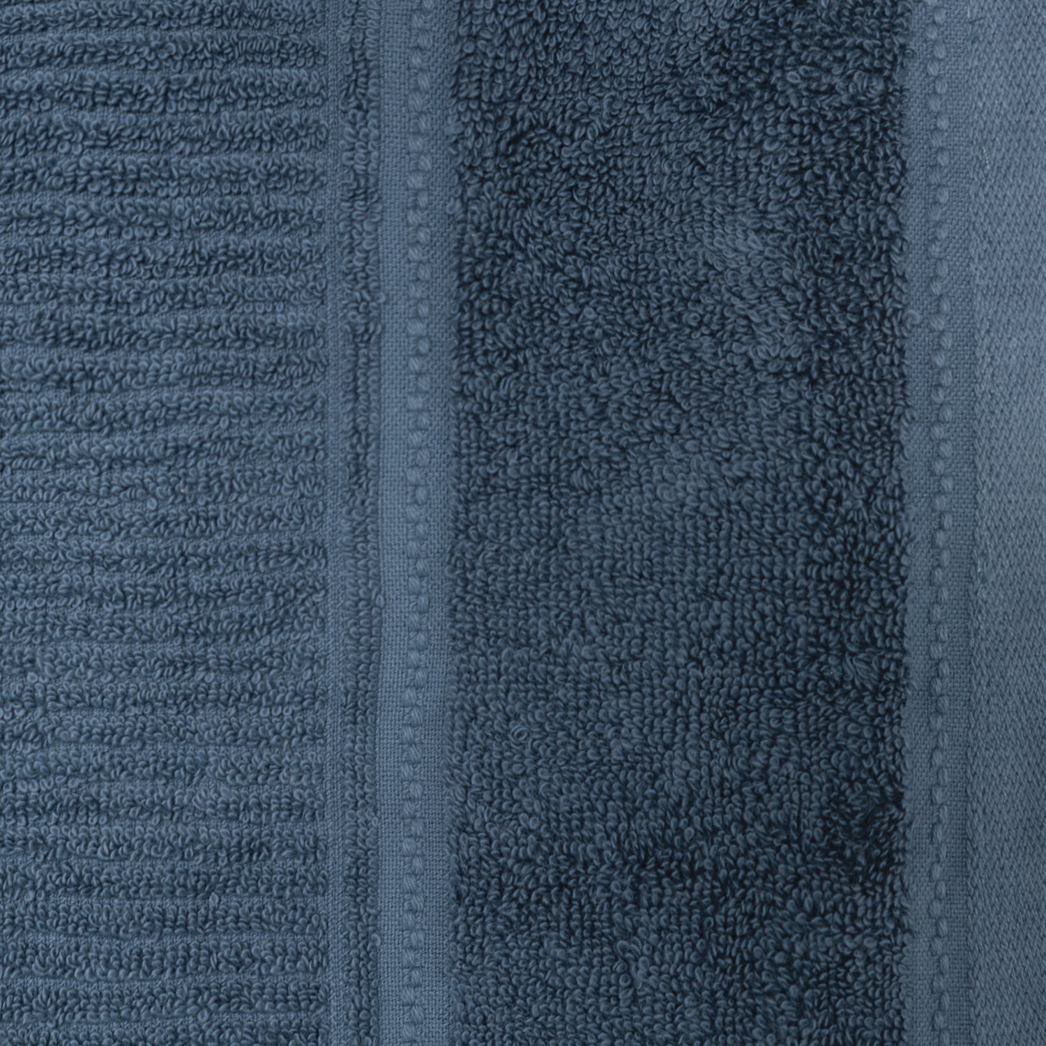 Close-up of the petrol Design Plus Tia towel, highlighting the plush texture and woven border detailing.