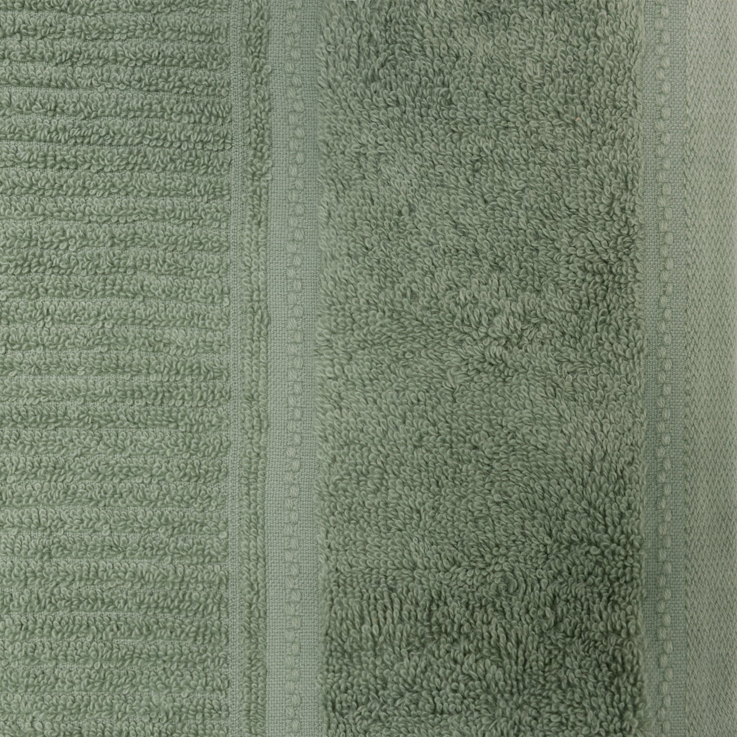 Close-up of the sea mist Design Plus Tia towel, highlighting the plush texture and woven border.
