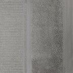 Close-up of the silver Design Plus Tia towel, showing the soft cotton loops and decorative border detailing.
