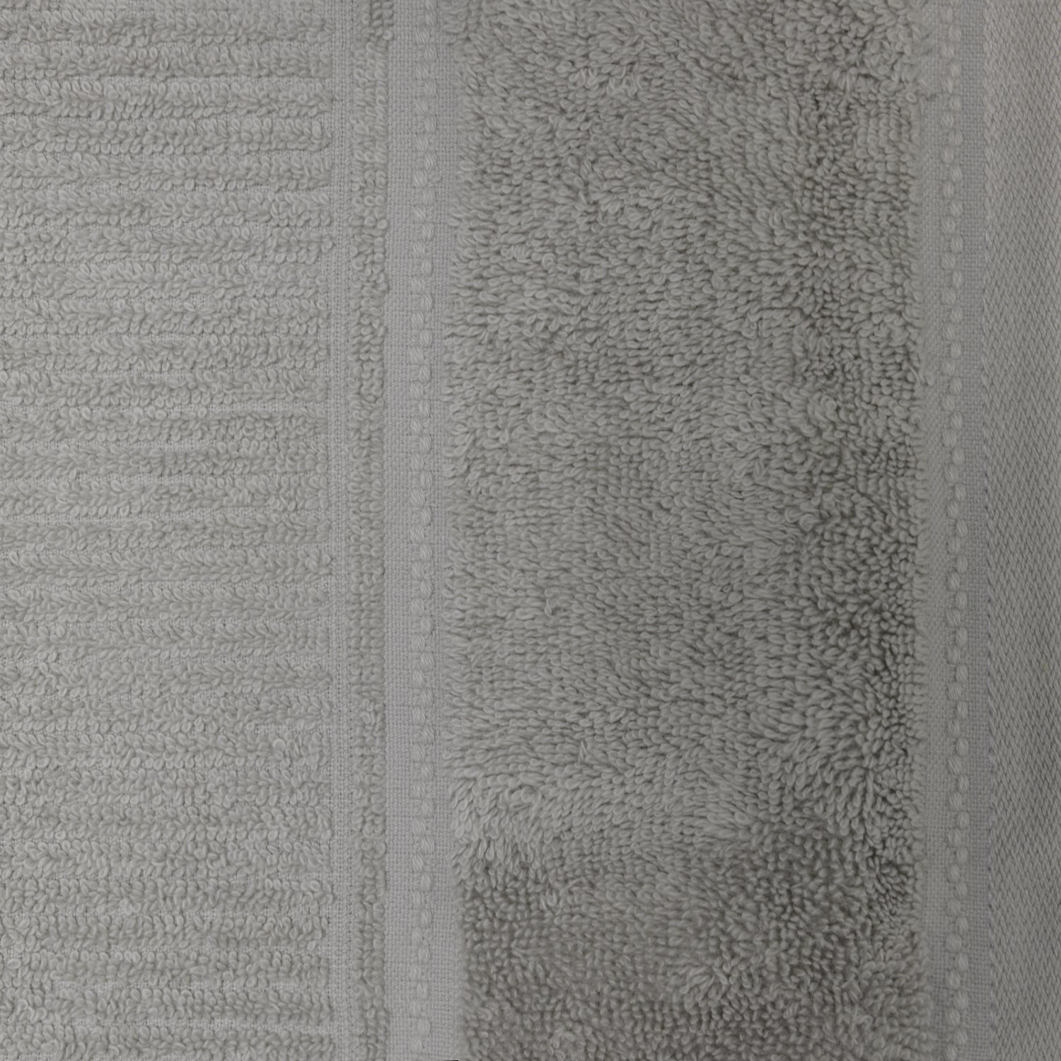 Close-up of the silver Design Plus Tia towel, showing the soft cotton loops and decorative border detailing.