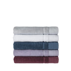 Stack of folded Design Republique Elani bath towels in Silver, White, Ocean, Lavender and Mulberry, displayed on a white background.