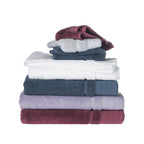 Stack of folded Design Republique Elani towels in Mulberry, Lavender, Ocean, White and Silver, displayed on a white background with matching face cloths on top.