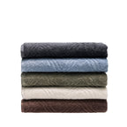 Folded Design Republique Gemma Plush 550gsm bath sheets stacked in charcoal, faded blue, khaki, ivory and coffee.