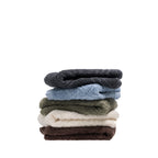 Folded Design Republique Gemma Plush 550gsm hand towels stacked in charcoal, faded blue, khaki, ivory and coffee.