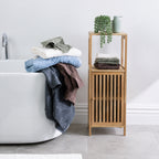 Design Republique Gemma Plush towel range displayed in a modern bathroom beside a bathtub and wooden storage cabinet.
