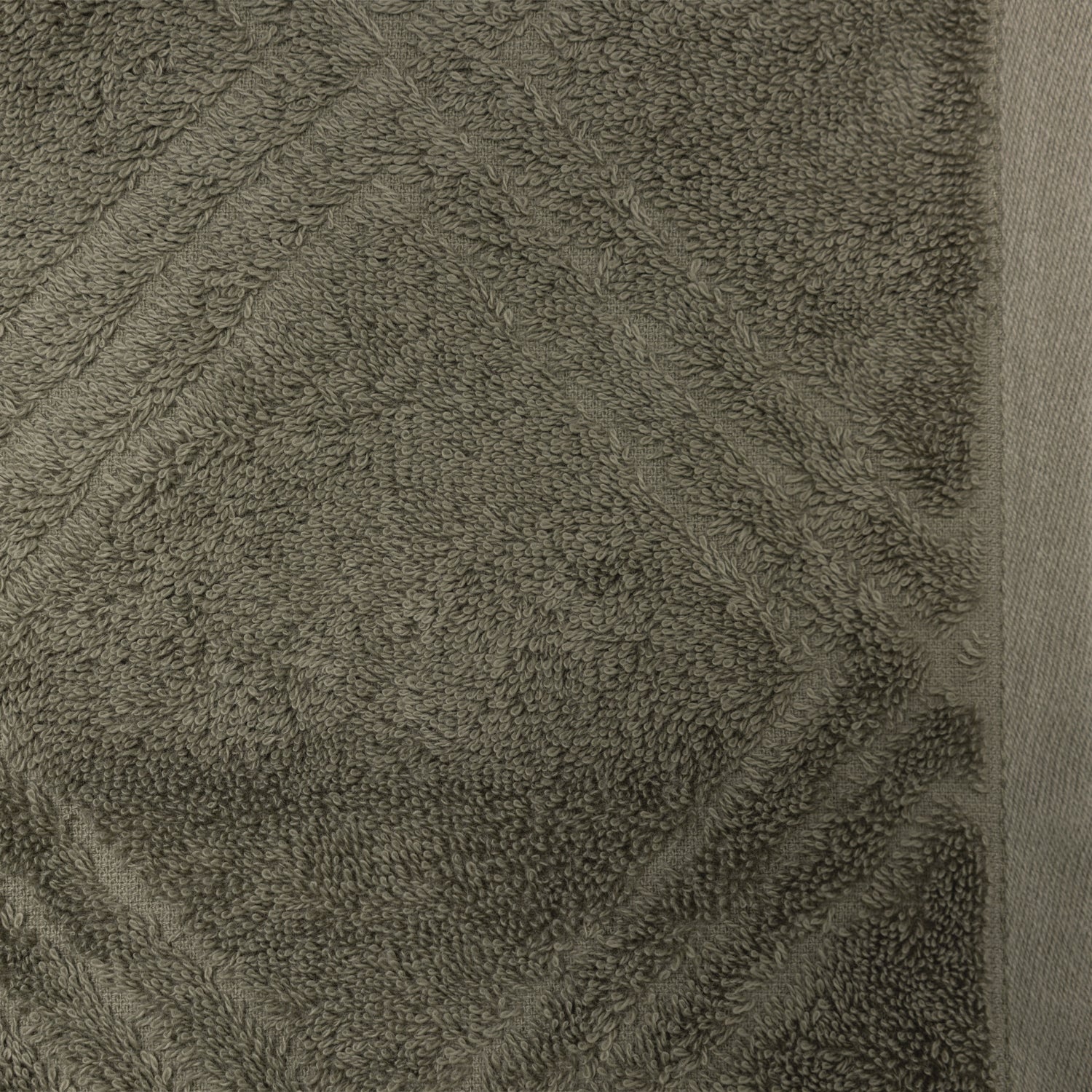 Close-up of the Design Republique Gemma Plush 550gsm face cloth in khaki, featuring a textured geometric pattern and smooth border.