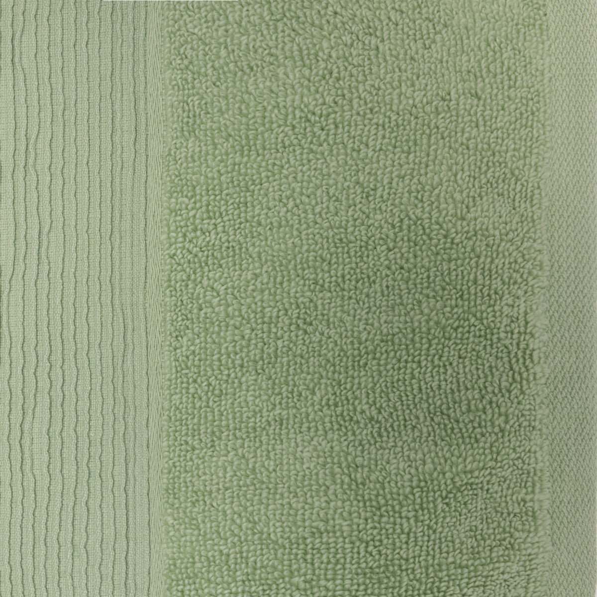 Close-up of a French pear green plush face cloth showing the soft looped texture and ribbed border.
