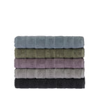 Stack of five folded Design Republique Addison textured bath sheets in faded blue, khaki, grape, silver and charcoal, featuring a contemporary textured stripe design.